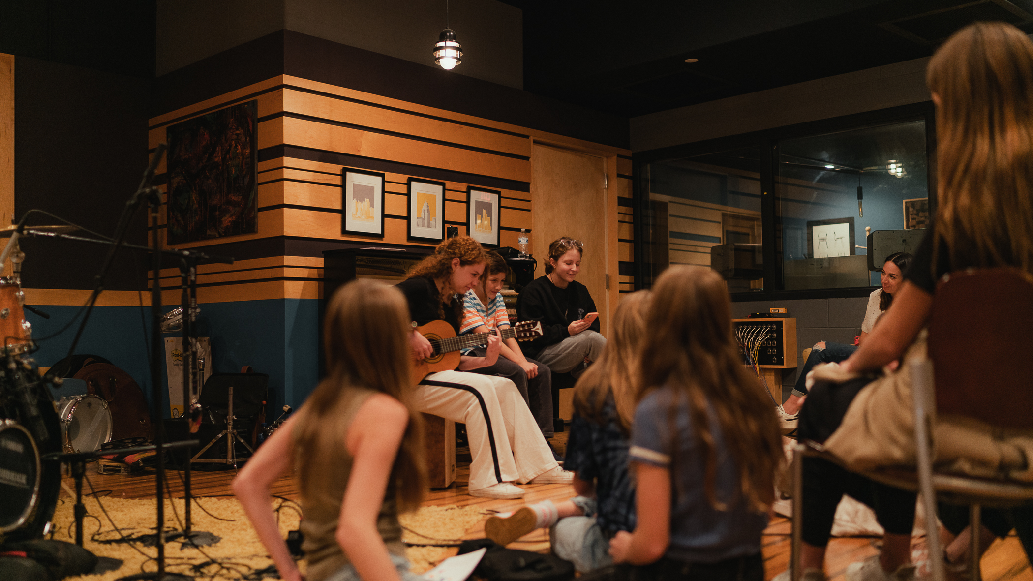A Kaleo Songwriters workshop in the round — one student plays guitar while the group listens